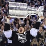 Dustin Brown raising the Stanley Cup triumphantly after helping the Los Angeles Kings win it all in 2014