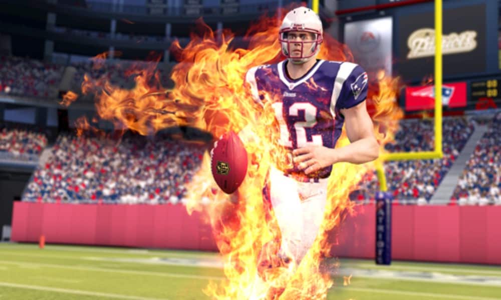 Virtual Tom Brady engulfed in fire from great play on the field - Image from NFL Blitz for the Xbox 360